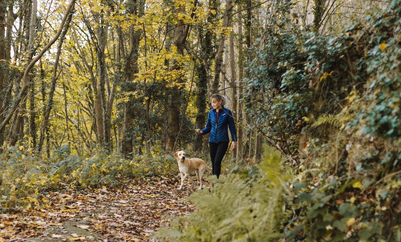 Woman walking her dog in the park