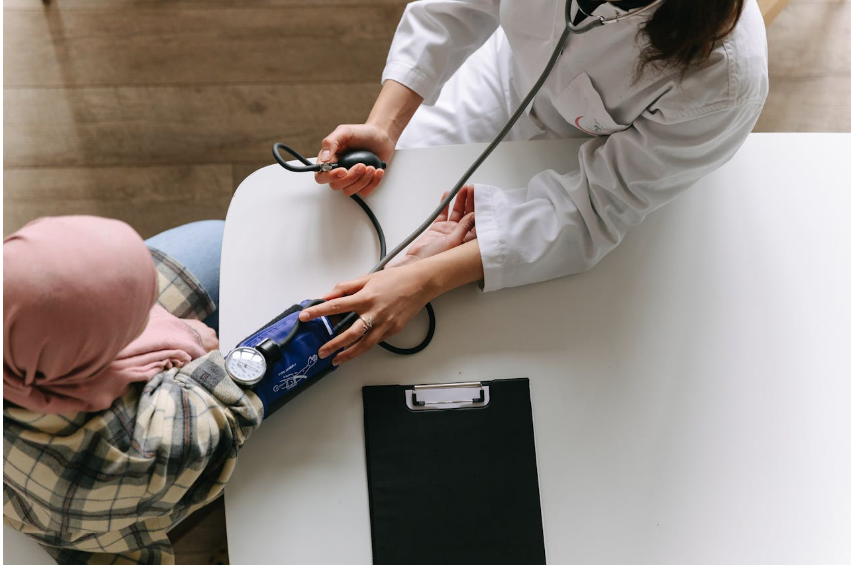 A woman getting her blood pressure checked