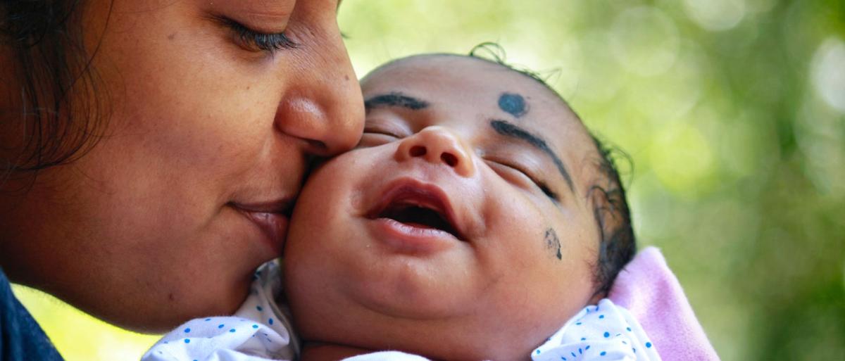 Mum kissing her baby