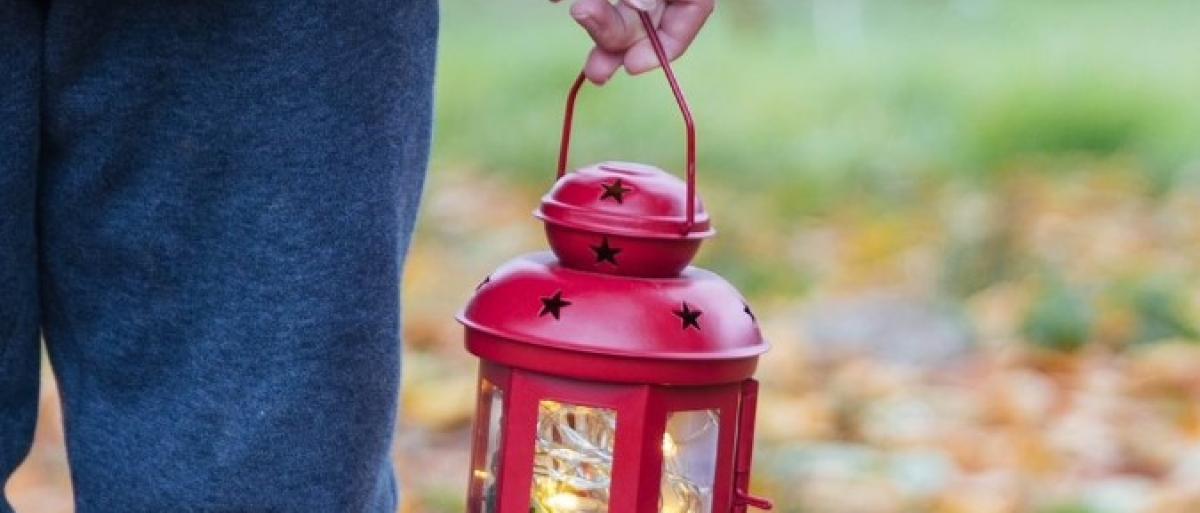 A MAN HOLDING A RED LANTERN