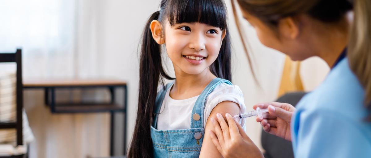 A child is getting immunised by a nurse