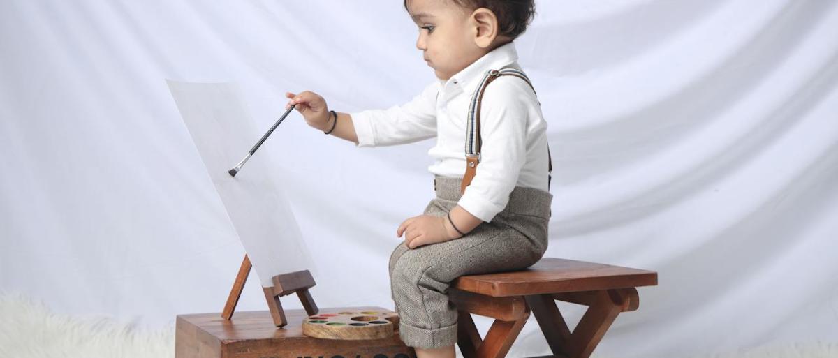 a toddler sitting to paint 