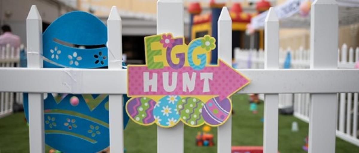 Sign saying Easter egg hunt in front of a children's play area