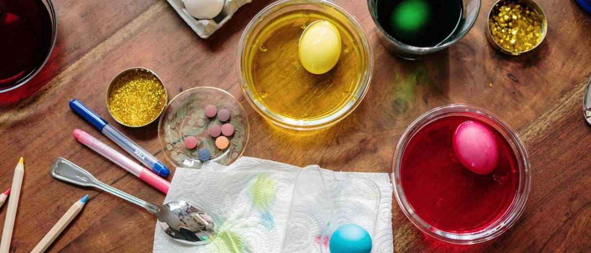 Water colors, brushes and painted eggs for Easter