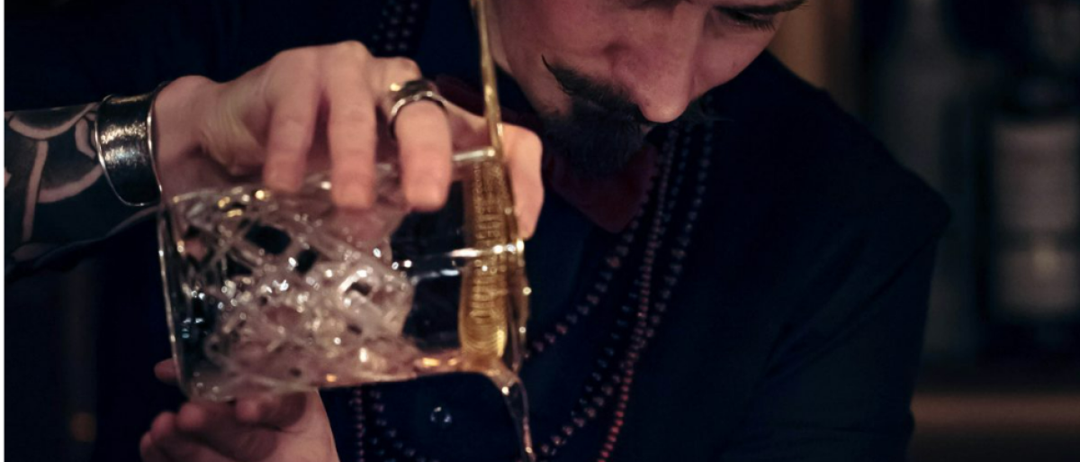 A bartender pouring drinks