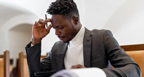 Man reading a legal document with pen in hand