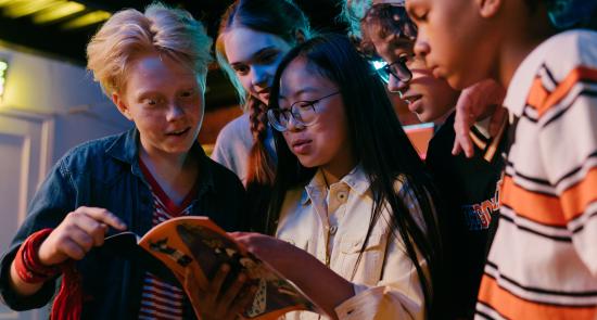 Children reading a book together