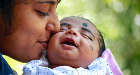 Mum kissing her baby