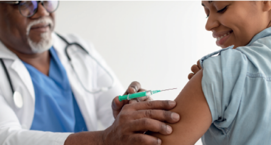 Woman getting vaccinated by a male doctor