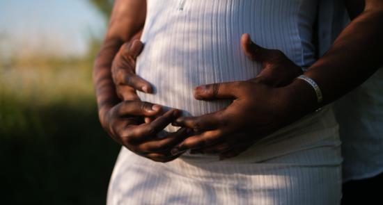 Pregnant woman holding her bump