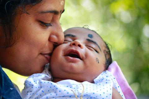 Mum kissing her baby